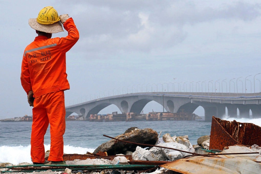 A construction worker looks on as the China-funded Sinamale bridge is seen in Male, Maldives. Photo: Reuters