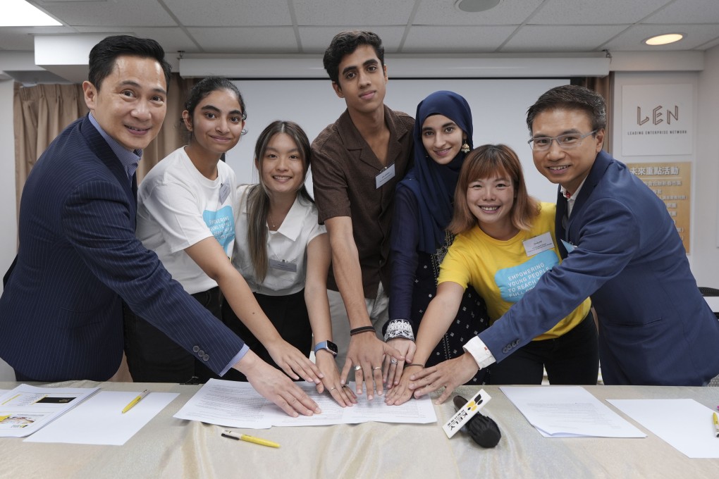Wayne Fong from Prudential Hong Kong and KELY Support Group members, , including Cindy Ng (second from right), pose with programme participants. Photo: Eugene Lee