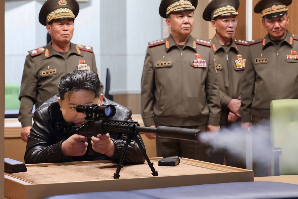 North Korean leader Kim Jong-un tests a sniper rifle during a visit to an arms manufacturer at an undisclosed location over the weekend. Photo: KCNA via KNS / AFP