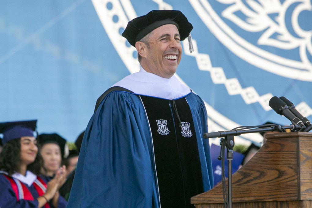 Jerry Seinfeld laughs on stage during the  graduation ceremony. Photo: Duke University via AP