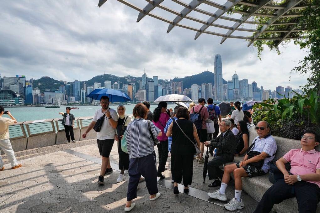 Tourists stroll along the Tsim Sha Tsui promenade. Starting May 27, residents from eight mainland cities will be able to apply for the Individual Visit Scheme to travel to Hong Kong. Photo: Elson Li