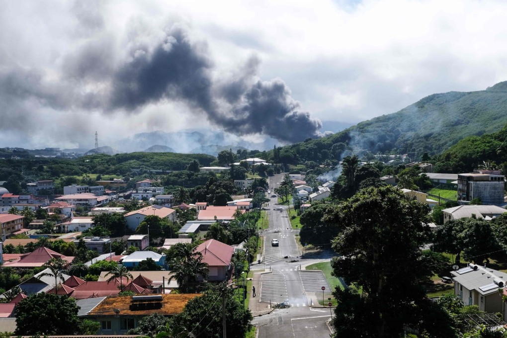 Smoke rises in the distance on Tuesday amid unrest in Noumea, New Caledonia, over a constitutional bill aimed at enlarging the electorate in the French overseas territory. Photo: AFP