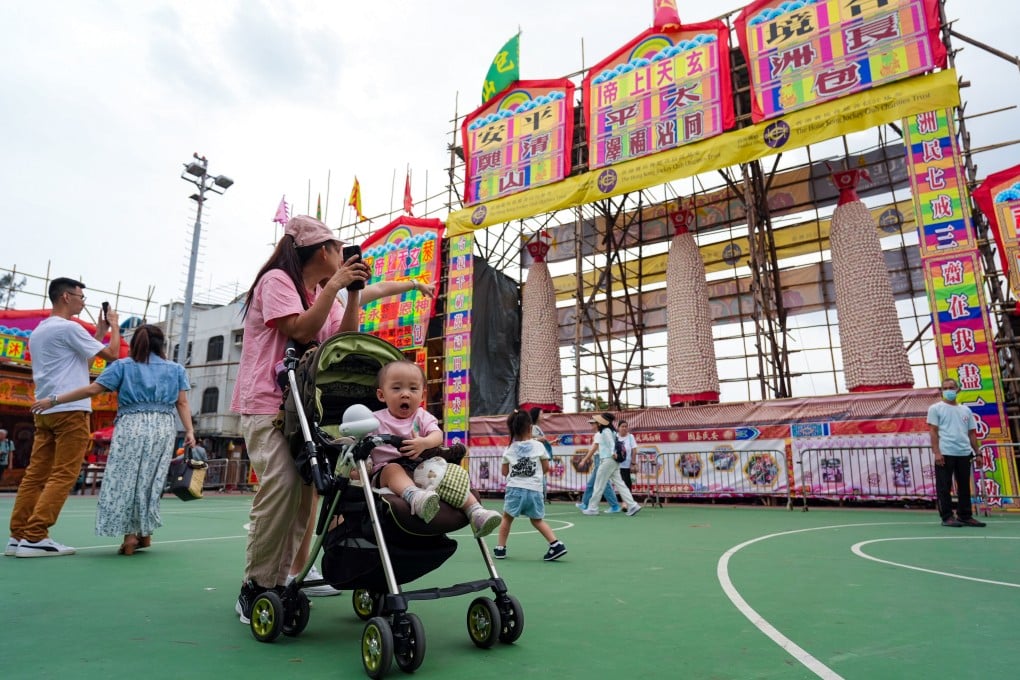 Tourists take photos of the bun towers on Cheung Chau. Photo: Eugene Lee