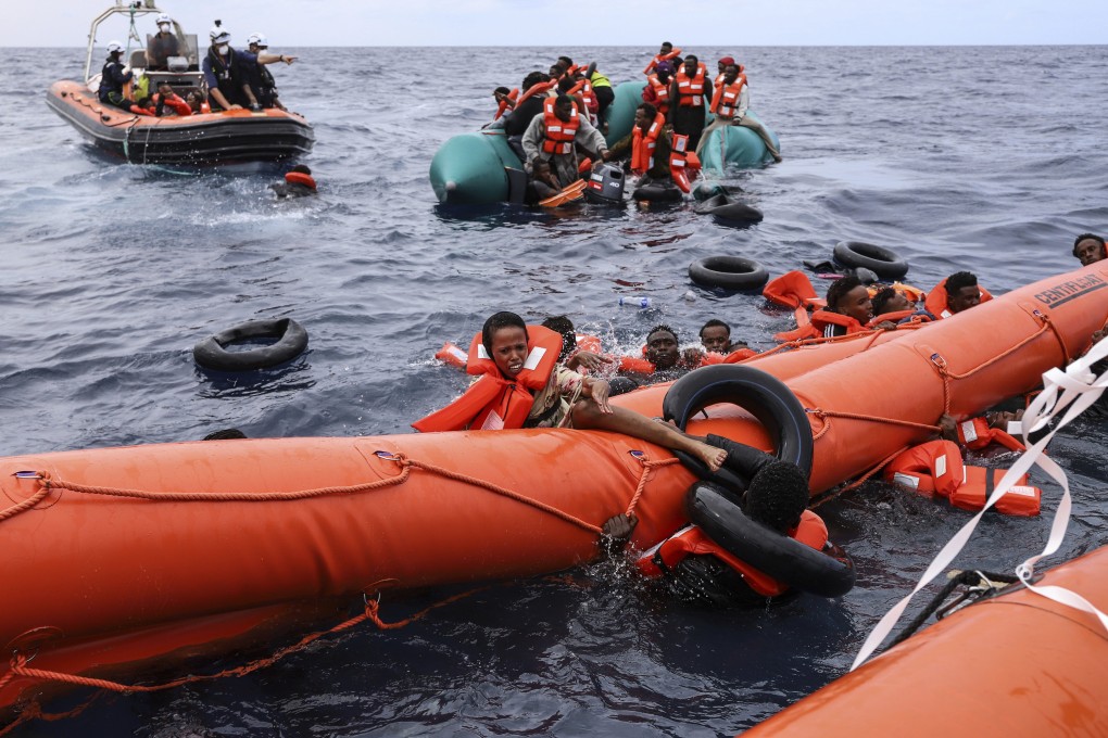 Migrants aboard a rubber boat end up in the water, while others cling on to a centifloat before being rescued near Libya. EU nations passed sweeping new reforms to the bloc’s failed asylum system. Photo: AP/File