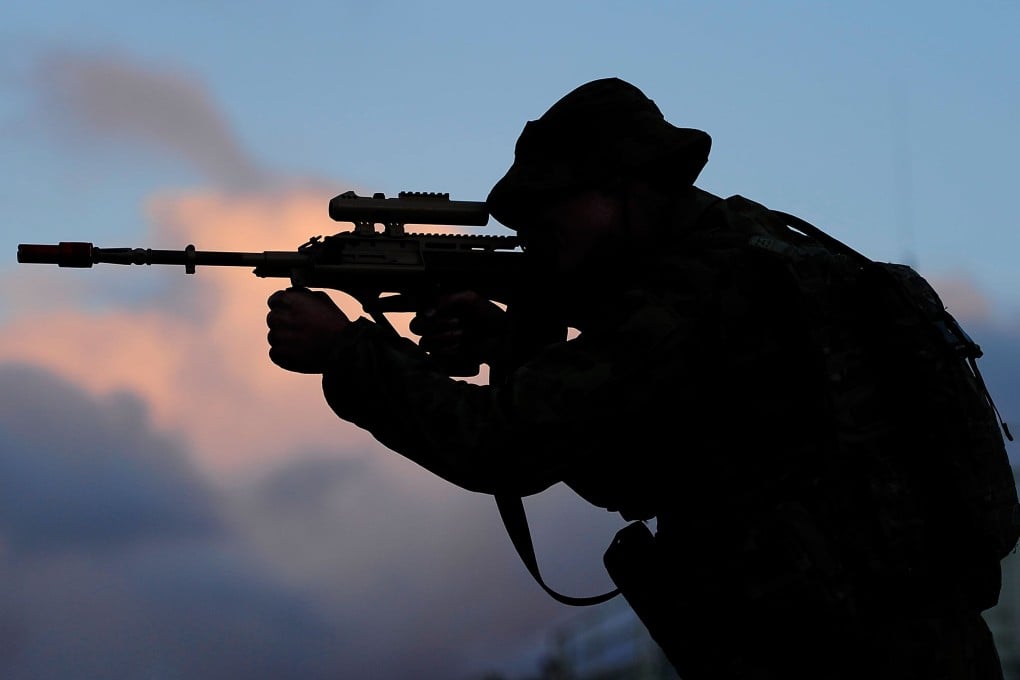 An Australian soldier looks through the sights of his rifle as part of a military exercise. More than 26,000 Australian uniformed personnel were sent to Afghanistan to fight alongside US and allied forces against Islamist forces. Photo: Getty Images