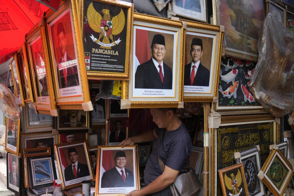 A vendor holds a portrait of Indonesian president elect Prabowo Subianto at a market in Jakarta. Prabowo, 74, is set to take over the presidency from Joko Widodo on October 20. Photo: AP
