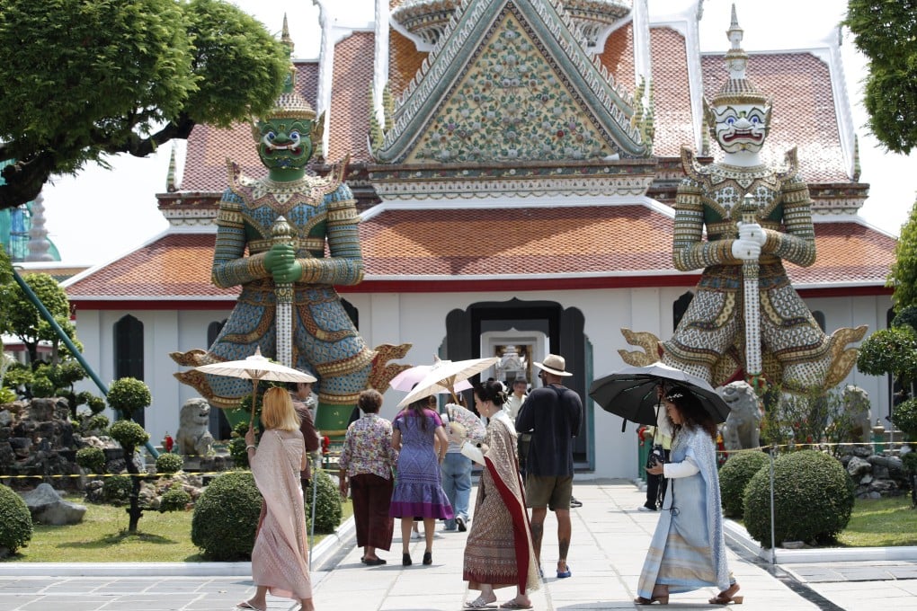 Tourists at Bangkok’s Temple of Dawn. Projections consistently show that low-lying Bangkok risks being inundated by the ocean before the end of the century. Photo: EPA-EFE