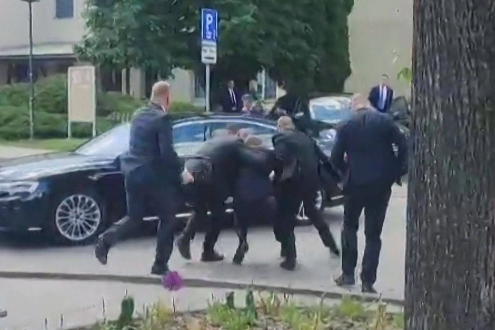 Security personnel carry Slovakia’s Prime Minister Robert Fico towards a vehicle after he was shot. Photo: RTVS via AFP