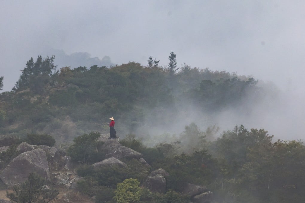A visitor is seen on Tai Mo Shan, the highest mountain in Hong Kong, 957 meters (3,100 feet) above sea level. Photo: Dickson Lee