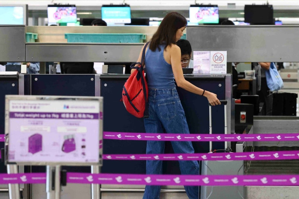 A passenger handles luggage at an HK Express counter at Hong Kong International Airport on May 8. Photo: Dickson Lee