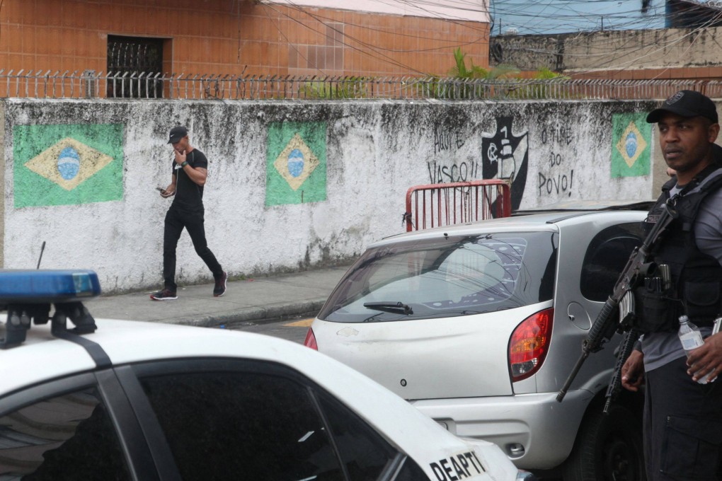 Civil and military policemen carry out a raid in the Complexo do Alemao favela in Rio de Janeiro. Photo: AFP