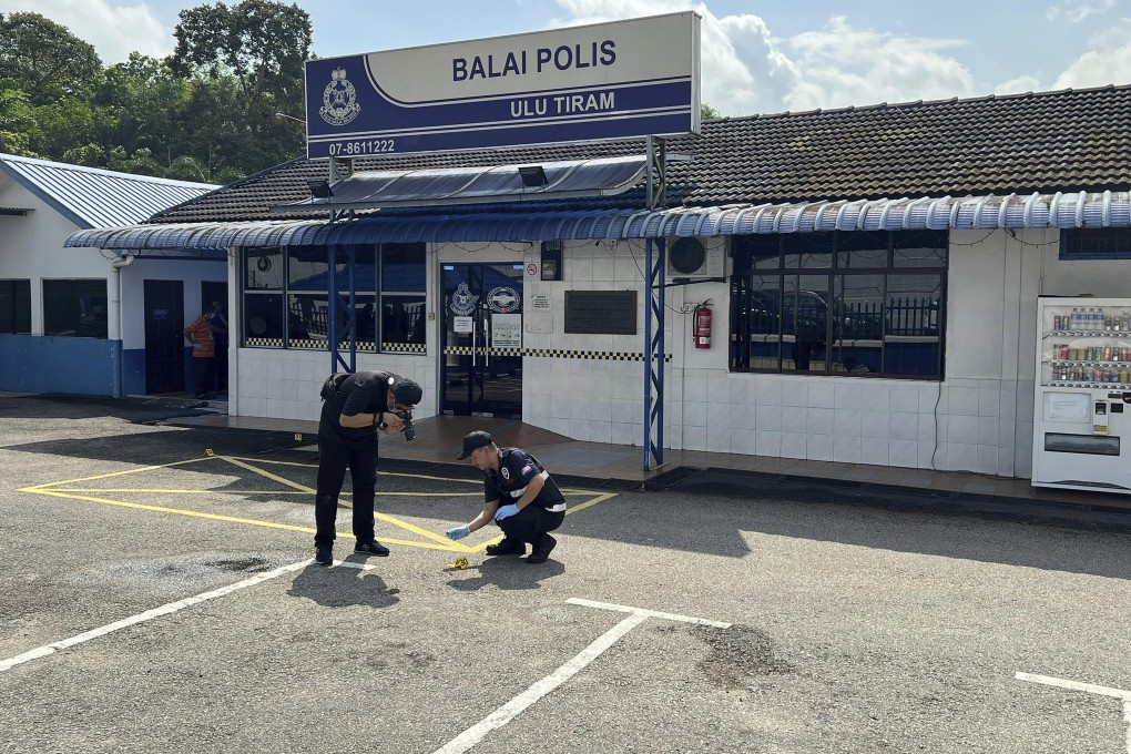 Forensic police officers outside Ulu Tiram station in Johor on May 17. Photo: AP