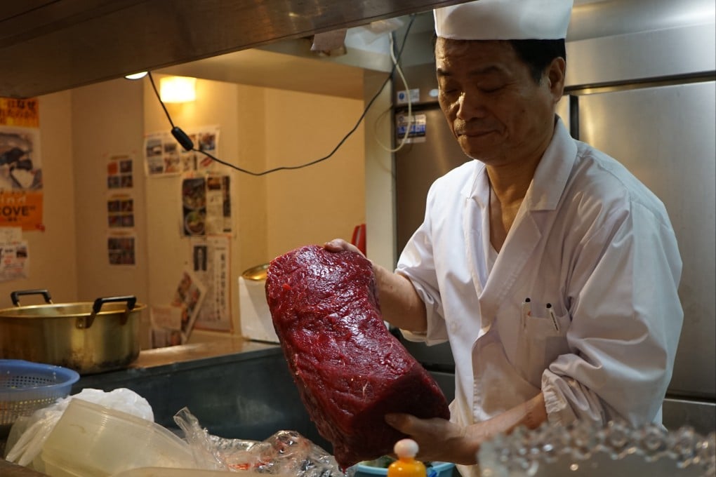A Japanese chef holds whale meat at a restaurant in Tokyo. Annual consumption of whale meat in Japan peaked more than half a century ago. Photo: AFP