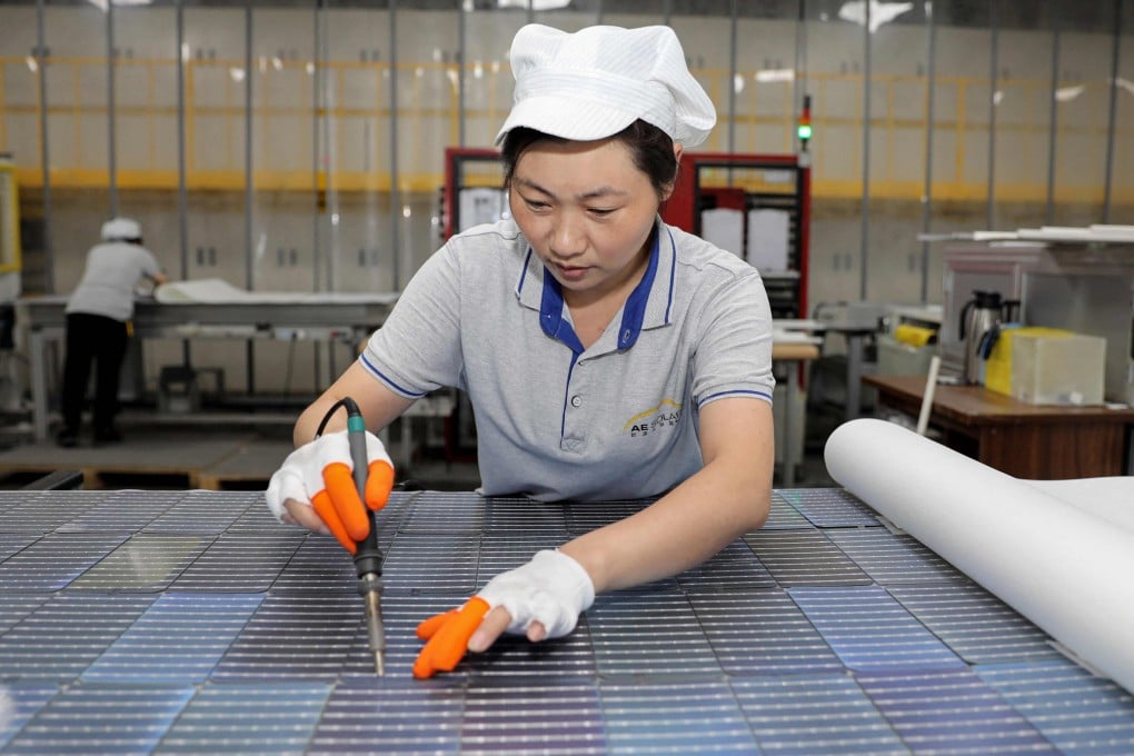 A worker produces solar photovoltaic modules used for solar panels at a factory in Huaian, Jiangsu province, on September 5, 2023. Photo: AFP