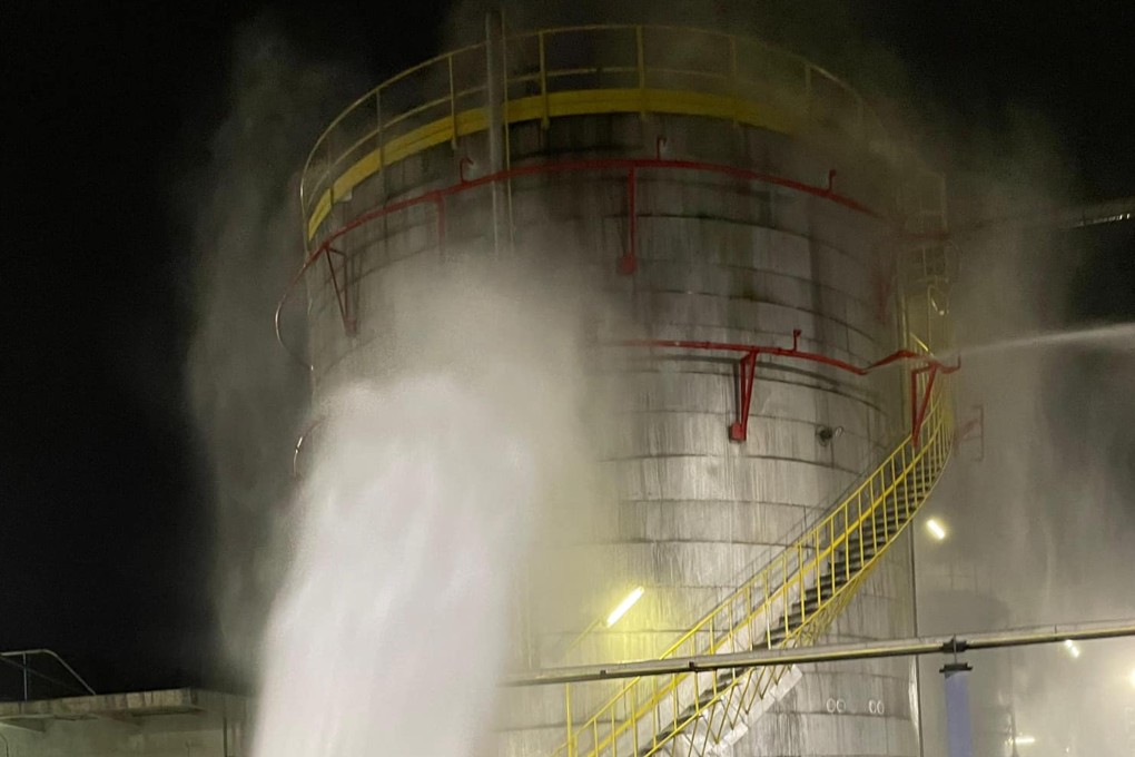 A remote-controlled jet of water douses a tank which leaked gas from toxic and flammable styrene in Kowloon in the early hours of Sunday. Photo: Facebook/FSD