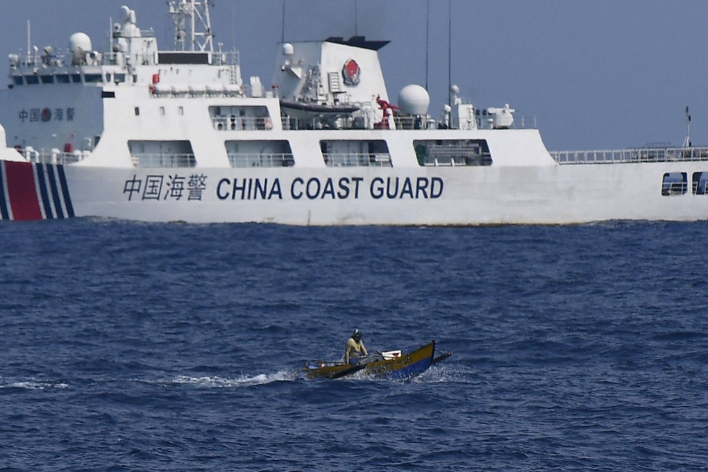 A Chinese coastguard ship monitors a Philippine fisherman in the disputed South China Sea on Thursday last week. Photo: AFP