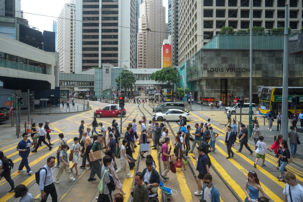 Pedestrians cross a road in Central, Hong Kong, on April 30, 2024. The city’s financial-services sector is a strong adopter of AI technology. Photo: Sam Tsang