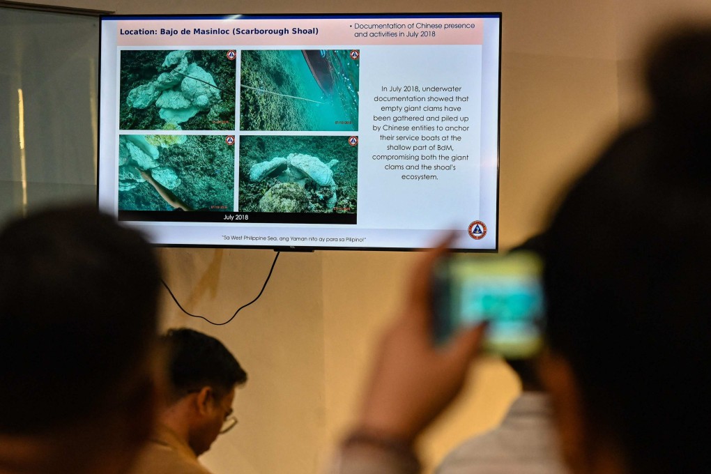 A journalist takes a photo of a presentation by the Philippine coastguard on Monday showing alleged Chinese activities in Scarborough Shoal. Photo: AFP