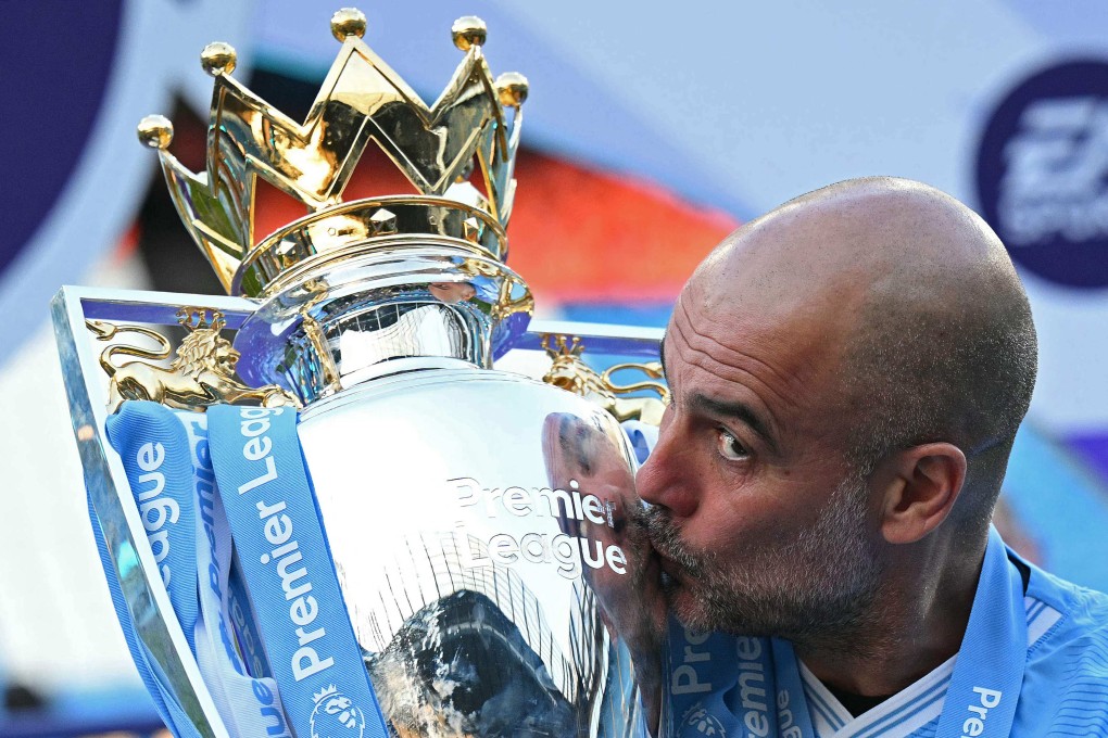 Manchester City’s Spanish manager Pep Guardiola kisses the Premier League trophy after his side’s 3-1 win over Ham United at the Etihad Stadium. Photo: AFP