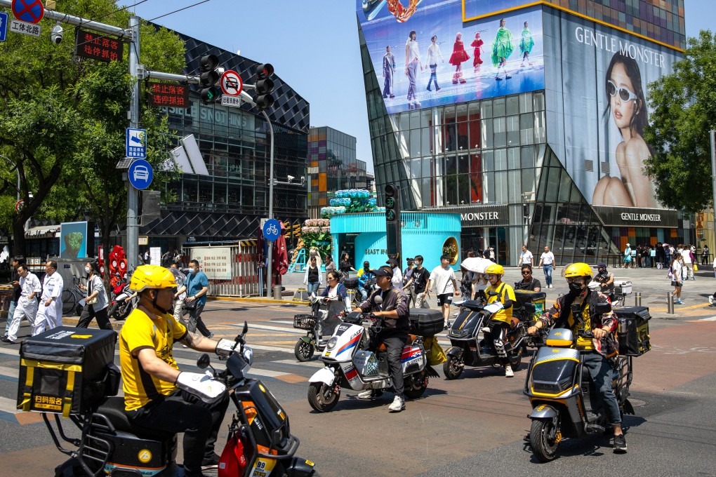 Riders and pedestrians negotiate an intersection in Beijing on May 17, 2024. Photo: EPA-EFE