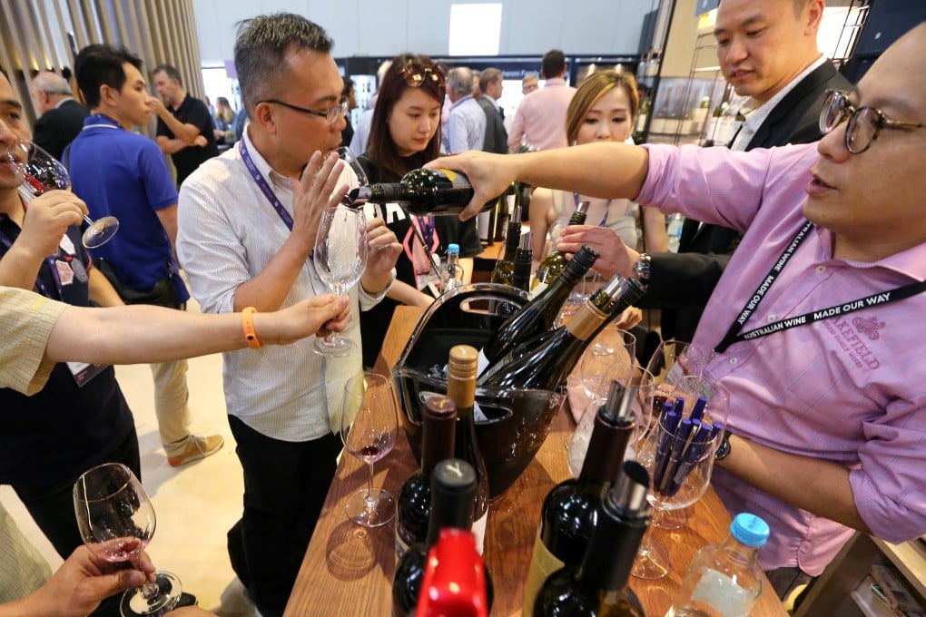 People try wine at the 2018 edition of Vinexpo Asia, in Hong Kong. The event is returning to the city this week after being being held in Singapore, but the move is purely transactional on both sides. Photo: Felix Wong