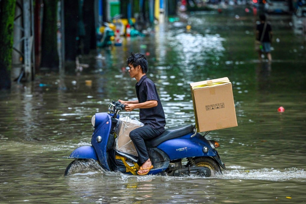 A man rides a scooter through a flooded street following heavy rain in Nanning, capital of south China’s Guangxi Zhuang autonomous region, on Sunday. Photo: AFP