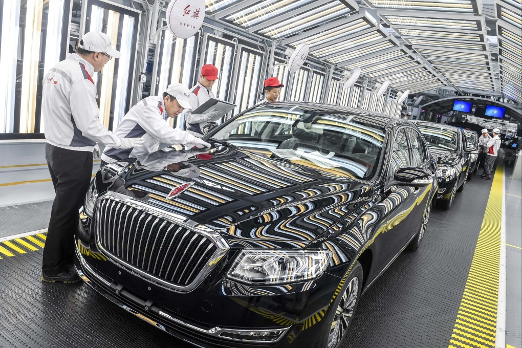 Staff members check FAW’s Hongqi cars in an assembly line in Changchun in April 2019. Photo: Xinhua