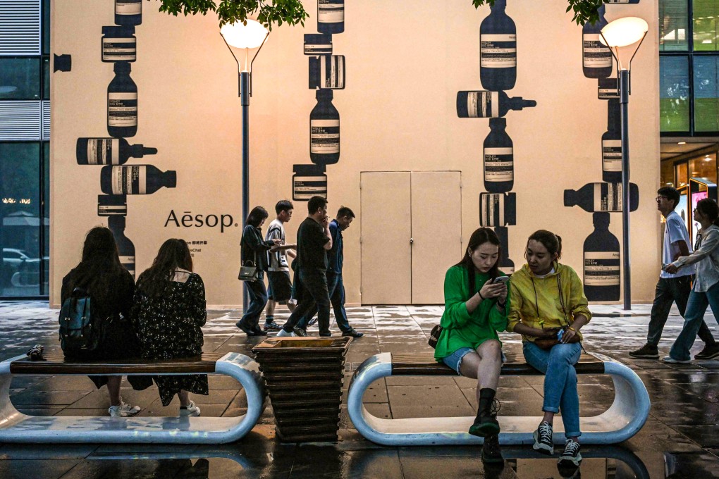 People visit a shopping mall in Beijing on May 10. Domestic consumption has replaced investment as the main driver of China’s economic growth. Photo: AFP