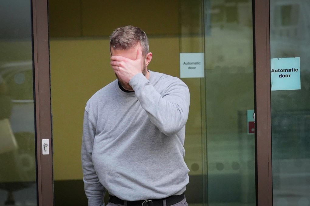 Matthew Trickett covers his face as he leaves Westminster Magistrates’ Court on May 13. Photo: AP