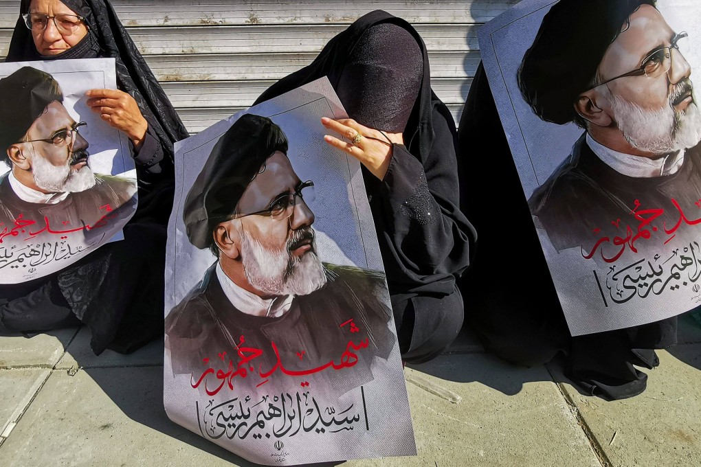 Mourners  in Tehran hold posters of Iranian president Ebrahim Raisi during a funeral ceremony. Photo: AFP