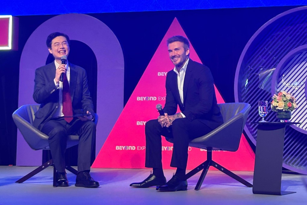 Grant Chum, CEO of Sands China, and former England football captain David Beckham speak at the Macau expo on May 23. Photo: Mia Castagnone