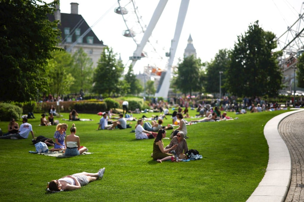 People sit near the London Eye. So far, 144,400 Hongkongers have arrived in the UK since the BN(O) scheme was launched in 2021. Photo: AFP