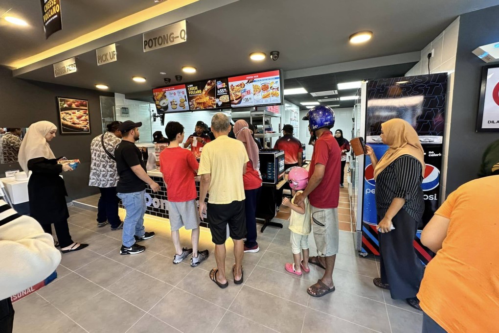 Customers at a Domino’s Pizza outlet in Malaysia. Photo: Facebook/DominosMY