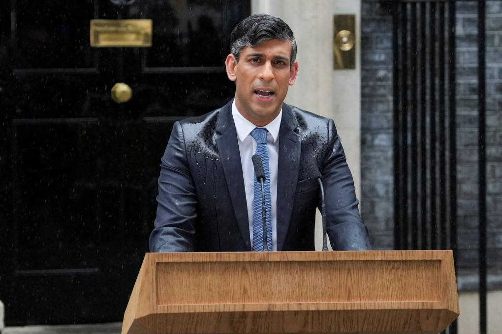 Rain-soaked Rishi Sunak announcing the UK election date. Photo: Reuters