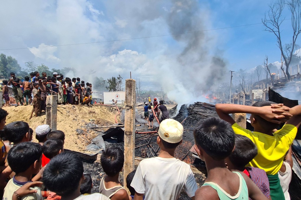 Rohingya refugees look through the debris of their houses charred by a fire at a camp in Cox’s Bazar. Photo: AFP