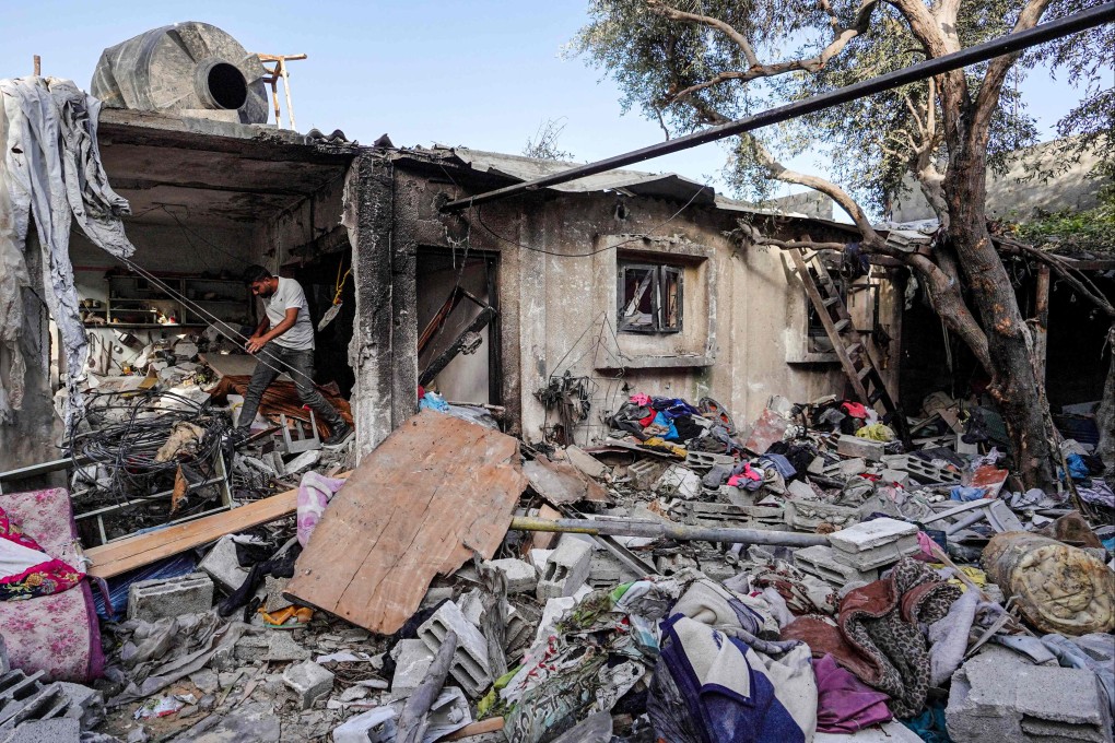 A Palestinian man walks on the rubble of a destroyed house in Nuseirat following Israeli bombardment overnight on May 23. Photo: AFP