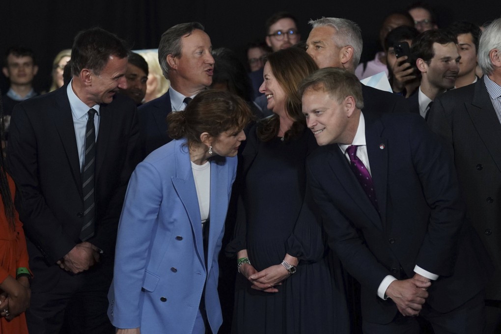 Cabinet ministers wait for Britain’s Prime Minister Rishi Sunak to speak during a campaign event. Photo: AP