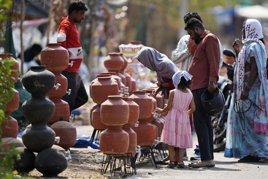 People shop for earthen water vessels, known locally as poor man’s refrigerator, from a roadside vendor in Hyderabad, India, on May 2. Photo: AP