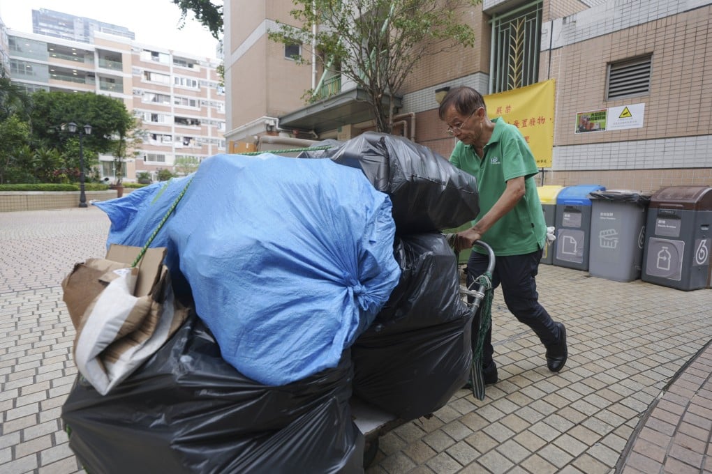 A cleaner carts rubbish bags at the refuse area of On Ning House in Tseun Wan, one of 14 sites that participated in the waste-charging trial. Photo: Eugene Lee