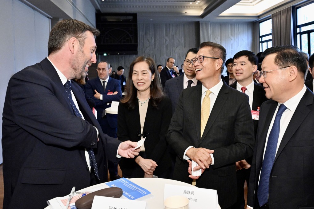 Delegation officials including finance chief Paul Chan (second right) meet French counterparts in Paris. Photo: SCMP