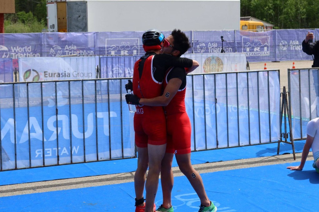 Jason Ng embraces teammate Robin Elg after clinching his Paris ticket. Photo: Handout