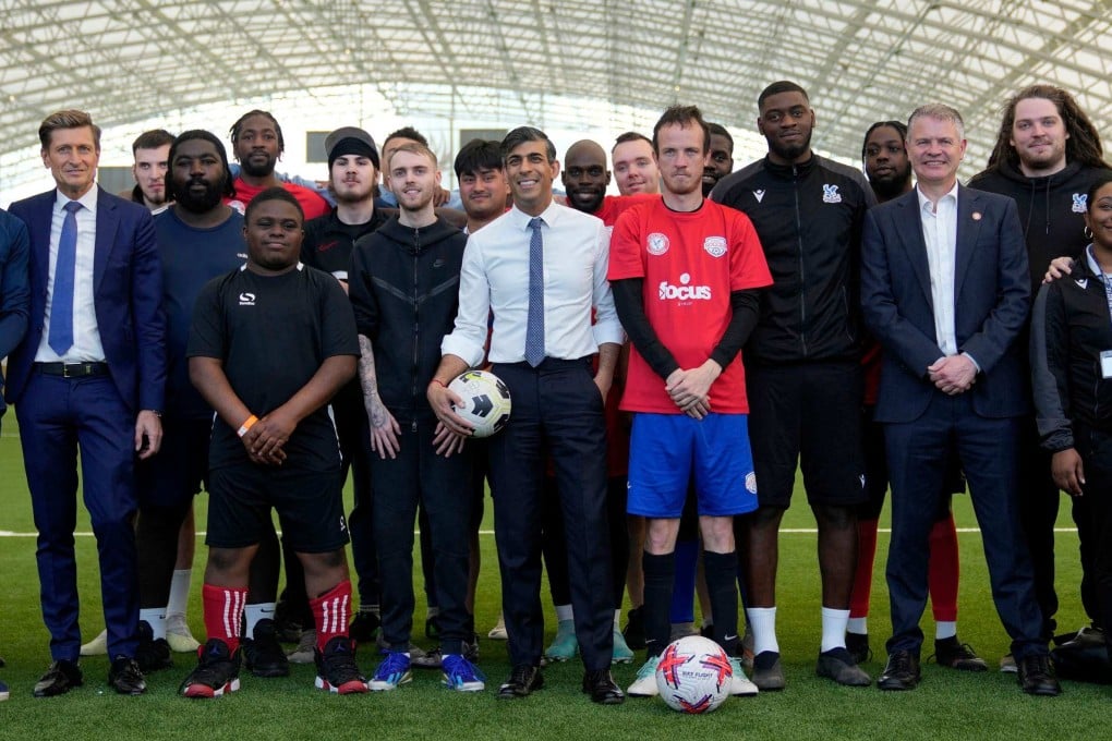 Sunak (centre), seen on a visit to a non-profit organisation, has opted for an election days after England’s probable first knockout match. Photo: AFP