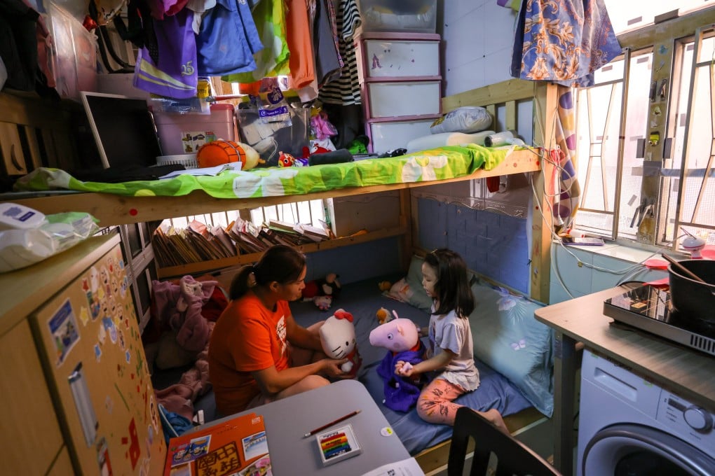 A single mother and her five-year-old daughter in their home in Sham Shui Po. The NGO poll found the median price for a subdivided studio flat was HK$4,300. Photo: May Tse