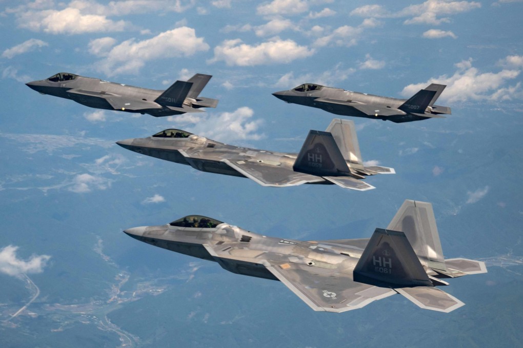 Two US Air Force F-22 fighter jets (front) fly with two South Korean Air Force F-35A fighter jets during a joint air drill in South Korea. Photo: Handout / South Korean Defence Ministry / AFP