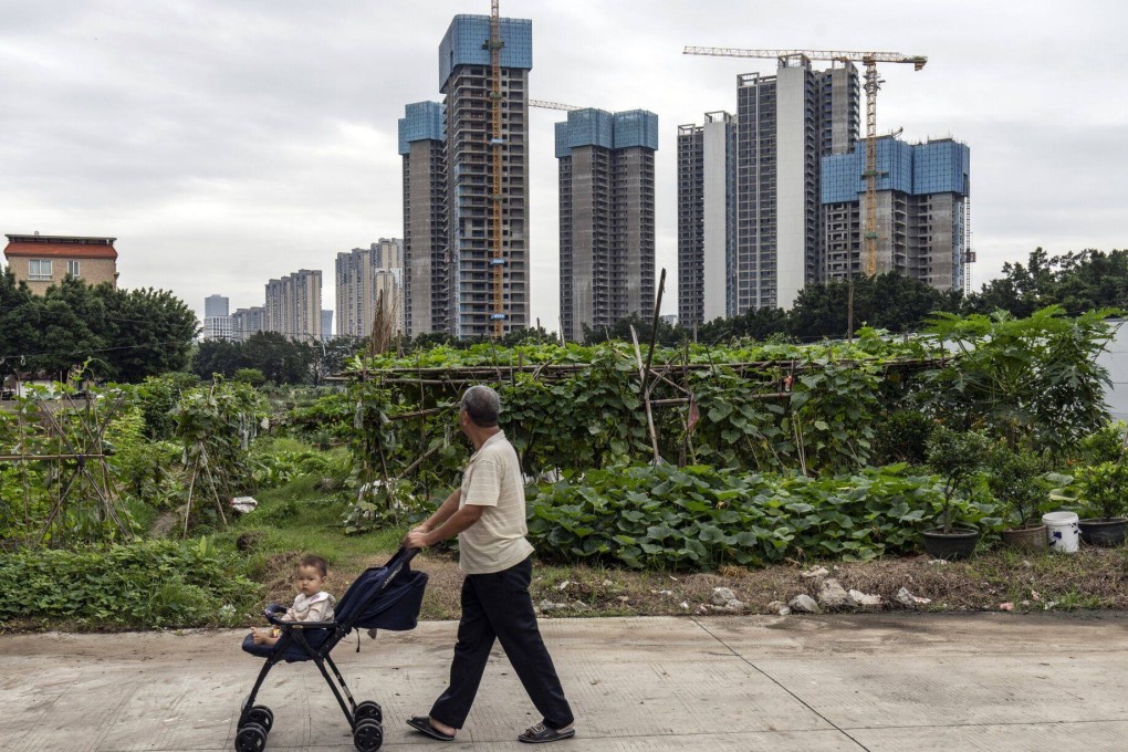 A pedestrian wheels a baby past residential buildings under construction at Country Garden’s Century Centre development in Foshan, Guangdong province, on May 22. The central government has taken several measures to ease the crisis in China’s property market, generating an upsurge in sentiment around Chinese stocks. Photo: Bloomberg