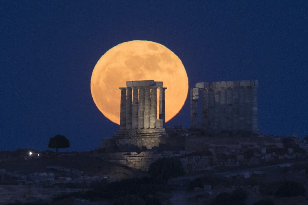 The moon is seen rising behind the Temple of Poseidon in Greece. Japan’s ispace Inc. aims to plant Unesco’s disc on the moon later this year. Photo: Xinhua