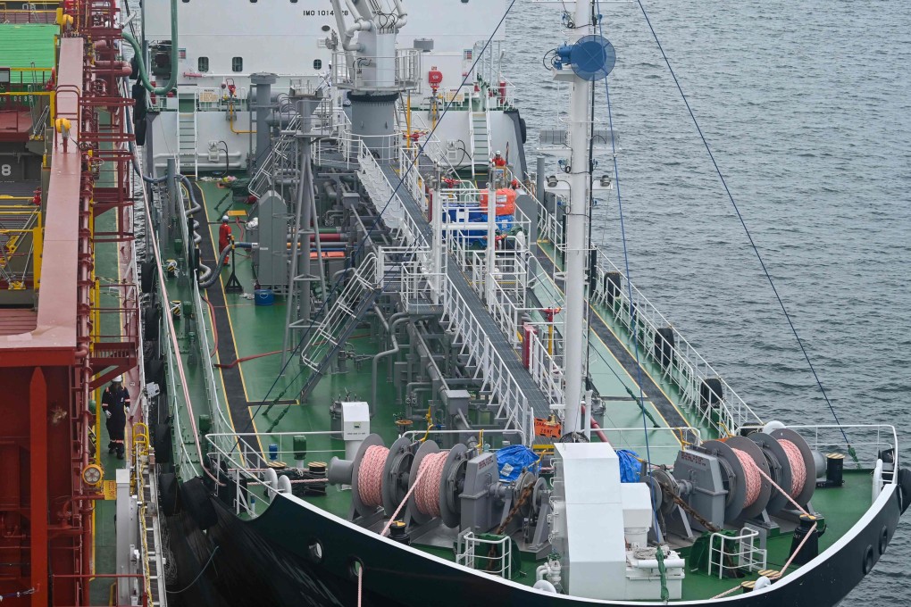 A Singapore shipping firm performed the world’s first simultaneous refuelling of a container ship with bio-methanol while it was being loaded with cargo in the port. Photo: AFP