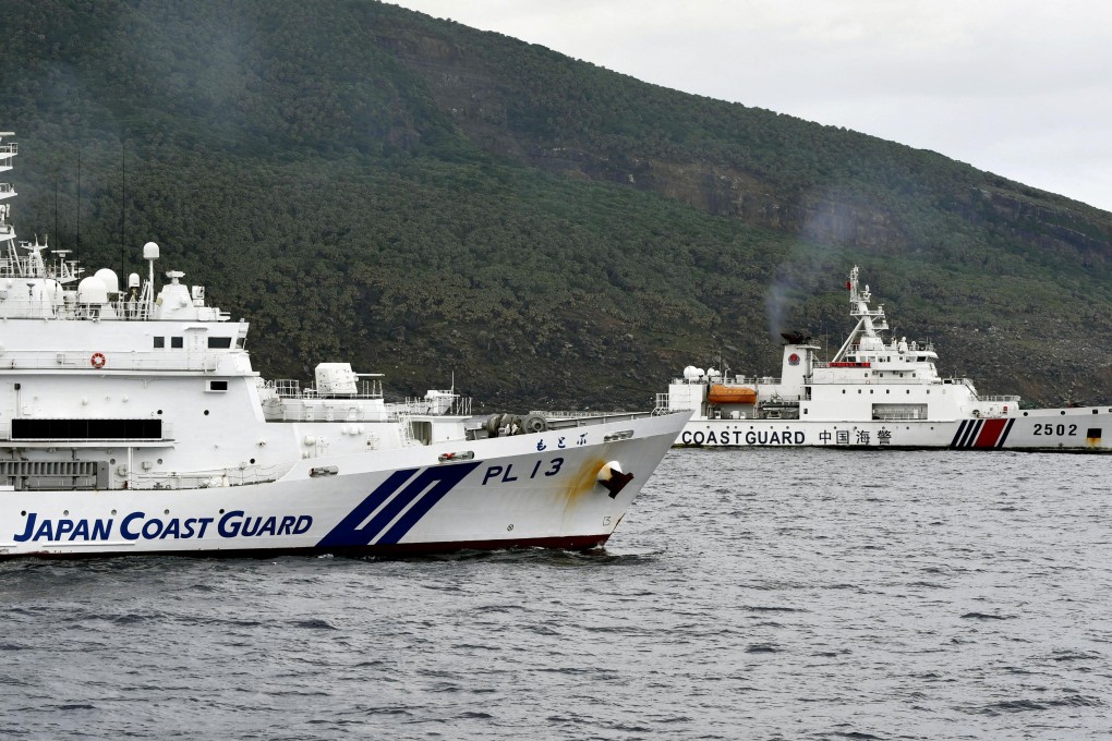 A Chinese coastguard ship sails near a Japanese coastguard vessel off Uotsuri Island, one of the disputed Diaoyu/Senkaku Islands in the East China Sea on April 27. Photo: Kyodo/via Reuters