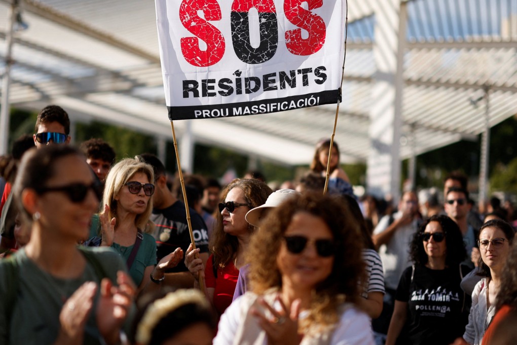 People in Palma de Mallorca, Spain, take part in a protest against mass tourism, which they say is responsible for increasing housing costs for locals. Photo: Reuters