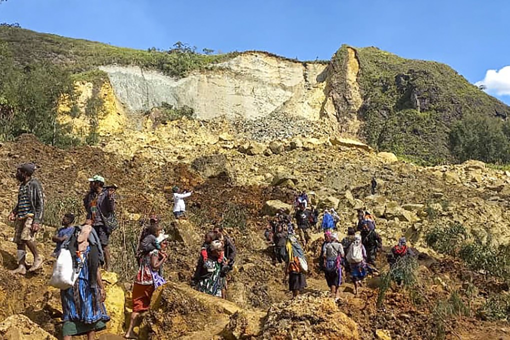 Villagers search through the landslide in Yambali village, Papua New Guinea, on Sunday. Photo: UNDP Papua New Guinea via AP